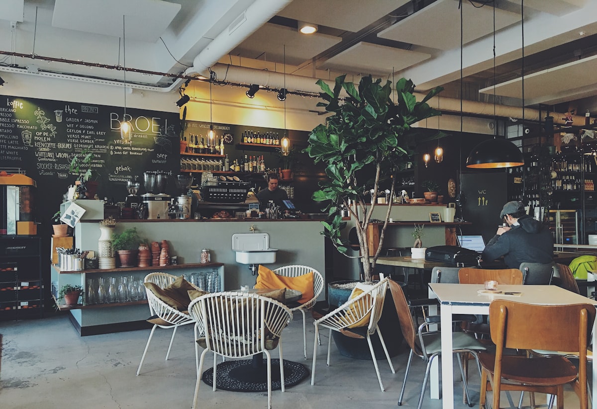 Ground floor coffee room at Konrad Cafe Luxembourg with sunlight and vintage armchairs